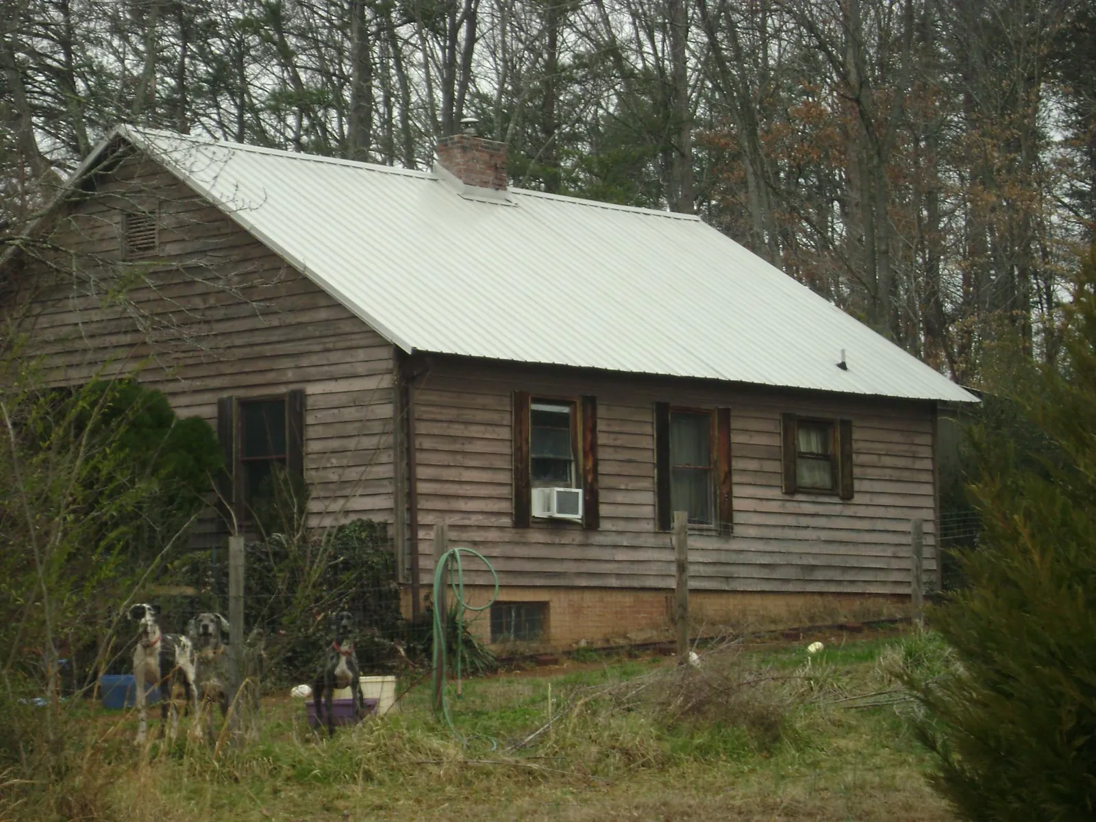 White metal roof on an old wood sided farmhouse, from a Metal Roof Installation job in Germantown